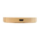 Circular bamboo wireless charger with a USB port visible on the side.