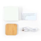 Wireless charger with cable, manual, and box on a white background.