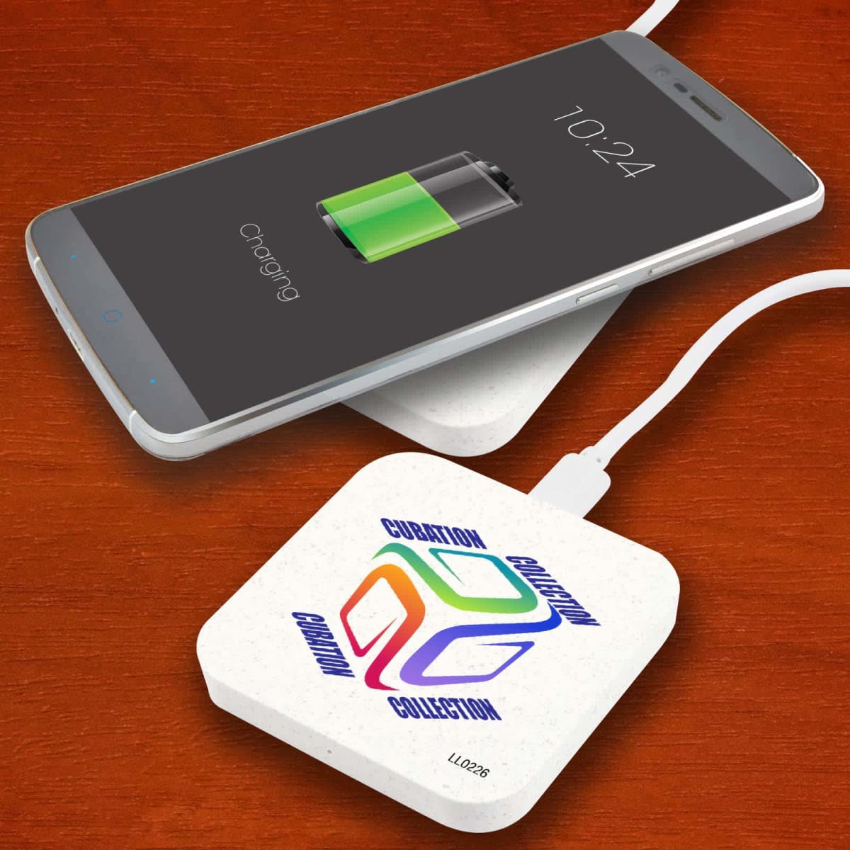 Smartphone charging wirelessly on a pad that says Guardian Collection.