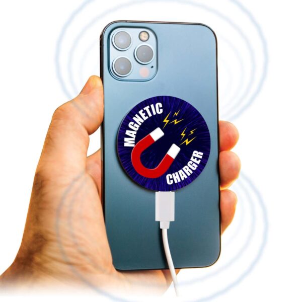 Hand holding phone with a circular magnetic charger attached to the back.