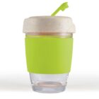 A transparent cup with a green sleeve and a beige lid featuring a spout.