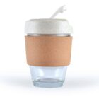 Reusable glass cup with cork sleeve and white lid against a plain background.