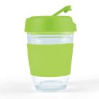 A clear cup with a green lid and grip band, featuring a flip-top opening.