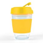 A clear glass with a yellow lid and grip band, featuring a flip-top spout.