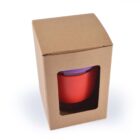 A red mug in a brown cardboard box with a clear window.