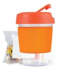 Orange container with flip lid beside a small bag of multicolored candies.