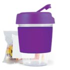 Purple cup with lid and a bag of colorful candy next to it.
