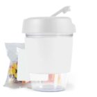 White container with a spoon on the lid, next to a packet of colorful candies.