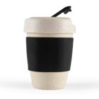 Reusable cup with a speckled design, black sleeve, and flip-top lid, against a white background.