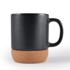 Black mug with handle on a cork coaster, isolated on a white background.