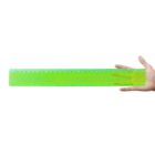 Hand holding a green translucent ruler against a white background.