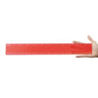 Hand holding a large red ruler horizontally, against a white background.