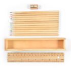 Wooden pencils, sharpener, box, and ruler aligned neatly on a white background.