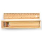 Wooden ruler, sharpener, and colored pencils in a wooden box.