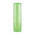 Green, empty lip balm tube standing upright on a white background.