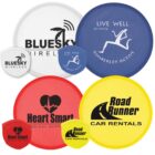Collection of colorful promotional flying discs with various company logos.