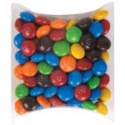 A clear plastic box filled with colorful candy-coated chocolates in red, blue, green, yellow, brown, and orange.