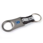 Keychain bottle opener with a black strap, silver accent, and two key rings. Logo printed on the opener.