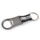 Metal bottle opener keychain with a black and silver strap and a keyring.
