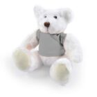 White teddy bear wearing a gray shirt, sitting against a plain background.
