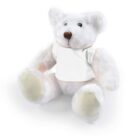 A fluffy white teddy bear wearing a plain white shirt, sitting against a white background.