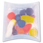 Assorted gummy candies in various shapes and colors inside a clear square plastic packaging.