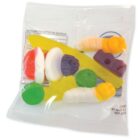 A clear bag with assorted gummy candies in different shapes and colors.