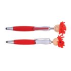 Two novelty pens with red bodies and doll heads featuring red yarn hair; one showing a smiley face.