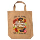 Beige tote bag with "Autumn Festival" text, colorful leaves, grapes, and event details.