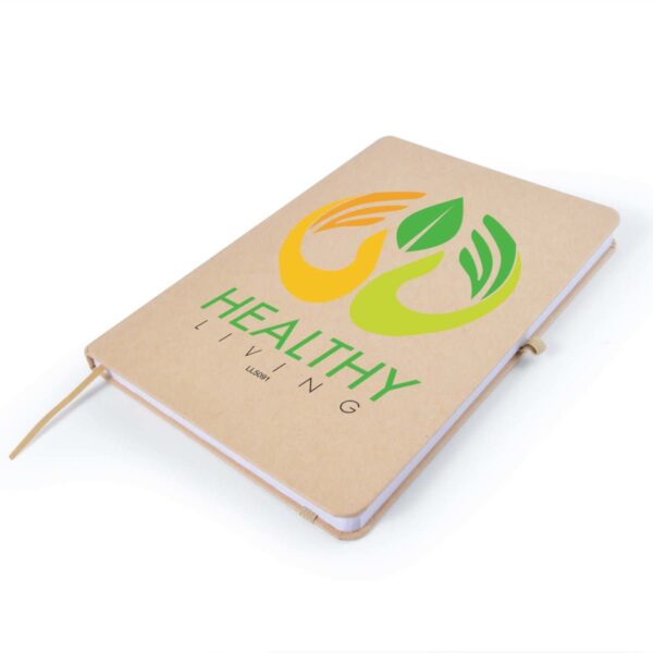 A beige notebook with a logo featuring two stylized hands holding green leaves, above the text HEALTHY LIVING in green. The notebook has rounded corners and a matching elastic closure.