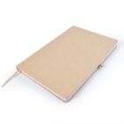 A closed, plain brown notebook with a beige elastic band and a matching ribbon bookmark is placed on a white surface. The notebook has rounded corners and appears to have blank pages inside.
