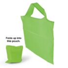 A bright green reusable shopping bag with handles is shown in full view. Next to it is a smaller, folded version of the bag, demonstrating its compact storage capability. The text reads, Folds up into this pouch.