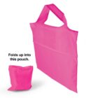 A pink foldable shopping bag with a handle, alongside its small matching pouch for storage. Text reads: Folds up into this pouch.