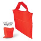 A bright red reusable shopping bag with handles is shown. Next to it, the bag is folded into a compact pouch. Text reads, Folds up into this pouch.