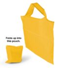 A bright yellow reusable shopping bag is shown unfolded and next to it is the same bag folded into a compact pouch. Text reads: Folds up into this pouch.