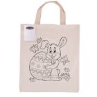 A beige tote bag with a line drawing of a cartoon bunny hugging a large decorated egg, surrounded by flowers, butterflies, and grass. A small pack of colored pencils is attached at the top corner.