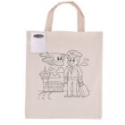 A beige tote bag featuring a black outline drawing. The drawing shows a smiling pilot with a suitcase, an airplane flying above, and an airport terminal with a control tower in the background. A set of colored pencils is attached to the bag.