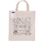 A beige tote bag features a black outline drawing of three people inside a submarine surrounded by fish, a dolphin, and an octopus. A set of colored pencils is attached to the upper corner of the bag.
