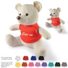 Two teddy bears wearing red shirts, with one featuring signatures and the phrase Sign me. Below are color swatches for customizable shirts in white, red, royal blue, black, yellow, orange, pink, lilac, purple, aqua, dark green, and grey.