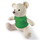 A plush teddy bear with cream-colored fur is sitting upright, wearing a green shirt. Its round ears, small eyes, and brown nose give it a cute appearance. The background is plain white.