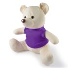 A beige teddy bear wearing a purple shirt sits upright on a white background. Its arms are outstretched and it has a round nose and ears.
