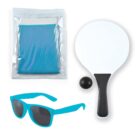 A collection of items including a turquoise pair of sunglasses, a blue cooling towel in packaging, and a white paddle with a black handle accompanied by a small black ball, all arranged on a white background.