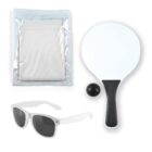 A paddle ball set with a white paddle, black ball, mesh bag, and white sunglasses. The paddle has a black handle, and the items are arranged on a white background.