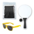 A set includes a white table tennis paddle with a black handle, a black ball, yellow sunglasses, and a black net inside a transparent plastic bag.