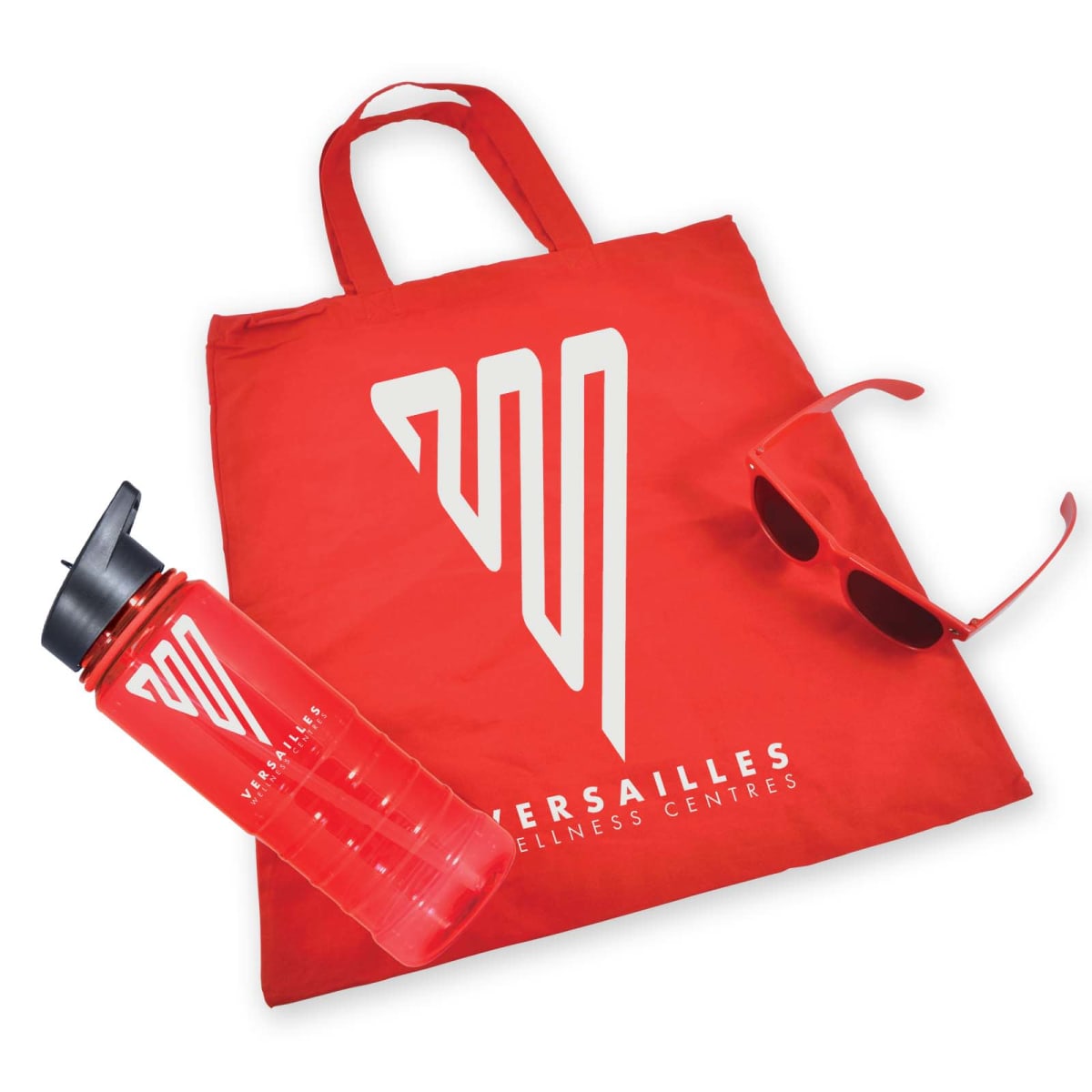 Red promotional items from Versailles Wellness Centres, including a tote bag, water bottle, and sunglasses, all featuring a white logo and text.