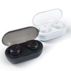 Black and white wireless earbuds in open charging cases. Both have transparent lids and four blue LED lights on the front. The earbuds have red indicator lights.