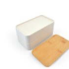 A two-tiered bento lunch box with a white base and a removed wooden lid, placed on a white background.