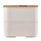 A two-tiered, rectangular bento box with a smooth, light beige exterior and a natural wood-finish lid. The box has rounded corners, creating a modern and sleek appearance.