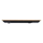 A side view of a thin digital weighing scale with a wooden top and black base. The scale is placed on a white background.