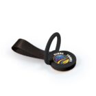 A round, black travel tag with a looped strap lies on a white surface. The tag displays a logo featuring a globe and leaf design, accompanied by the words GLOBE TRAVEL.